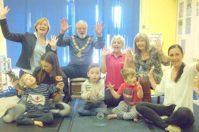 Rainbow Centre chief executive Lara Bull, back left, Mike Wilks and back right, his wife Kay, with staff and pupils