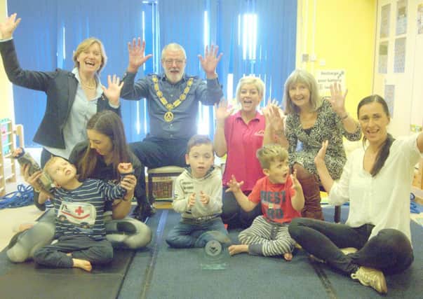 Rainbow Centre chief executive Lara Bull, back left, Mike Wilks and back right, his wife Kay, with staff and pupils