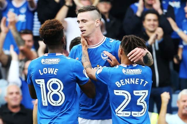 Oli Hawkins, centre, celebrates scoring against MK Dons Picture: Joe Pepler