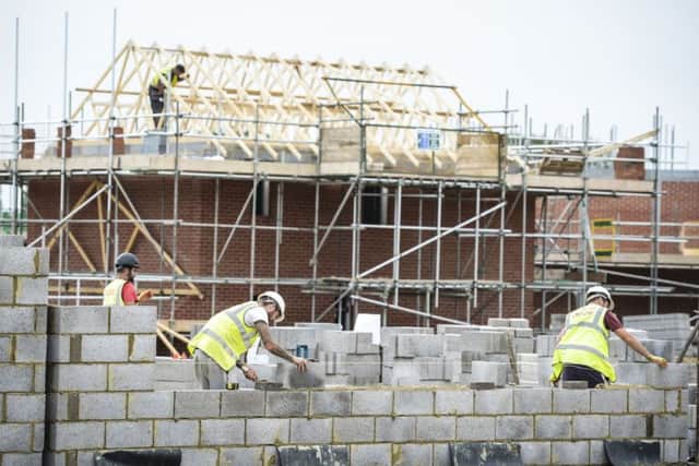 File photo of builders: Ben Birchall/PA Wire