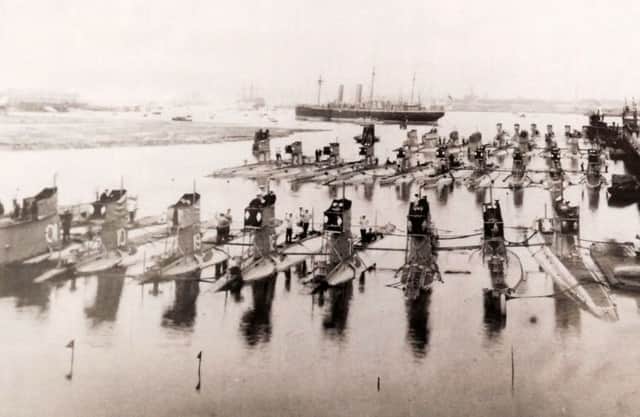 A gaggle of 33-submarines tied up at HMS Dolphin, Gosport, pre-January 1922. HMS Victory is in the far distance.