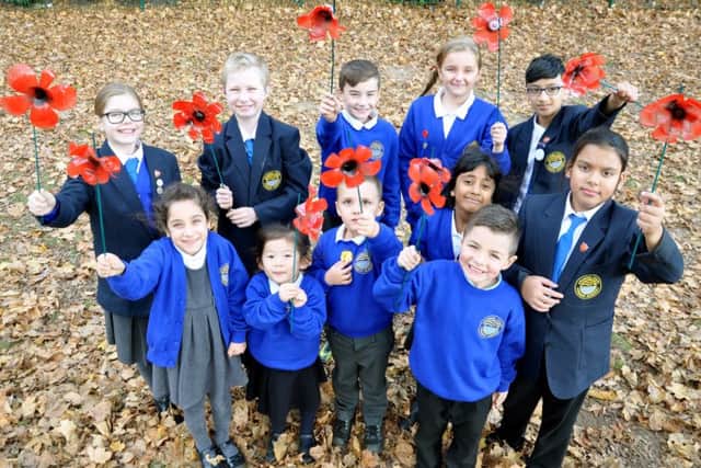 Children from Arundel Court Primary Academy with some of the poppies