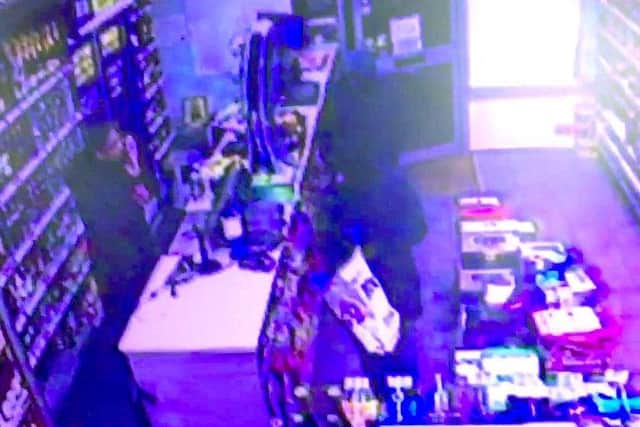 The two robbers walk into Bargain Booze in Elm Grove