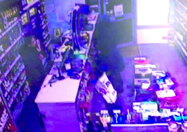 The two robbers walk into Bargain Booze in Elm Grove