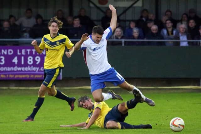 Brett Poate challenges a Rushden player. Picture: Alison Bagley