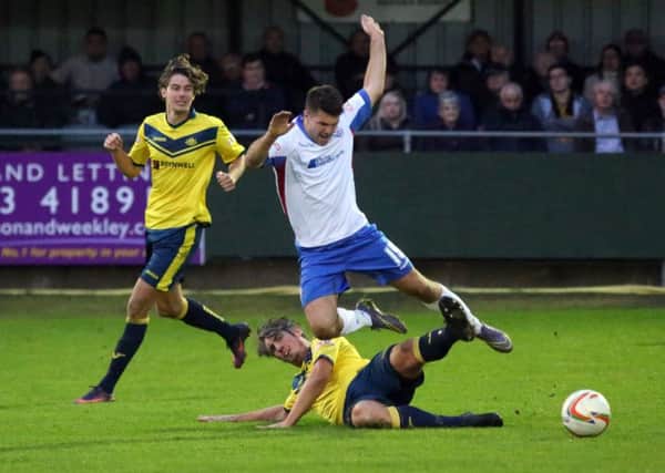 Brett Poate challenges a Rushden player. Picture: Alison Bagley