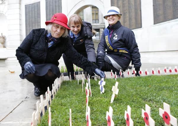 Members of the Association of the Wrens Jan Vanson, Kathryn Simmons and Gail Foster placing crosses in memory of Wrens who losst their lives on HMS Aguila   Picture: Habibur Rahman