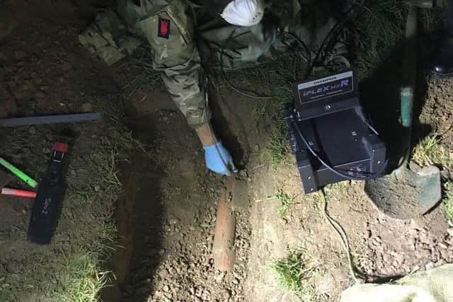 A bomb disposal team works to remove the device. Picture: Royal Navy