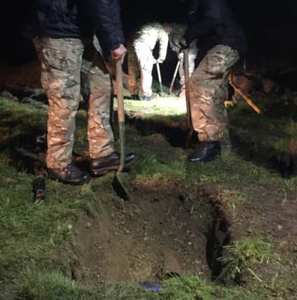 A bomb disposal team works to remove the device. Picture: Royal Navy