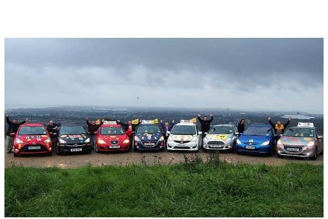 Instructors from left, Nick Pink, Jane Holt, Peter Russell, Toby Scott, Jamie Gerathy, Jenny Bonner, James Early and Adrian Wilkinson show off their spotted cars at Portsdown Hill ahead of tomorrow's relay. Picture: Jane Holt