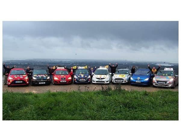 Instructors from left, Nick Pink, Jane Holt, Peter Russell, Toby Scott, Jamie Gerathy, Jenny Bonner, James Early and Adrian Wilkinson show off their spotted cars at Portsdown Hill ahead of tomorrow's relay. Picture: Jane Holt