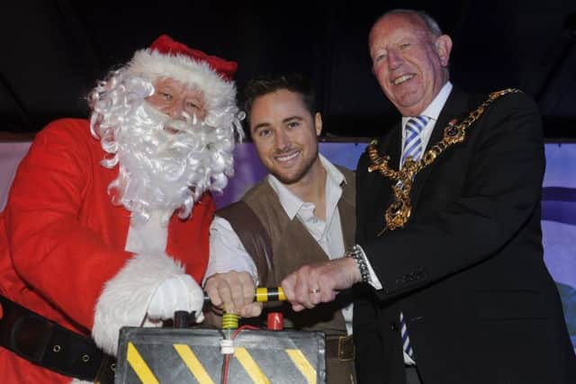 (L-r) Father Christmas, Marcus Patrick and the Lord Mayor of Portsmouth Councillor Ken Ellcome switch on the Christmas lights  Picture: Ian Hargreaves