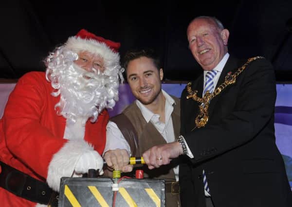 (L-r) Father Christmas, Marcus Patrick and the Lord Mayor of Portsmouth Councillor Ken Ellcome switch on the Christmas lights  Picture: Ian Hargreaves