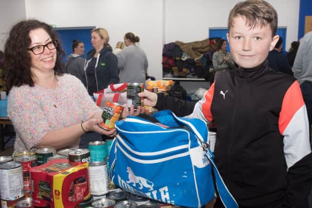 Hayley Mullins receives some donations from Stanley Hardham, 10.  Picture: Keith Woodland