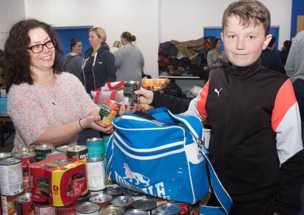 Hayley Mullins receives some donations from Stanley Hardham, 10.  Picture: Keith Woodland