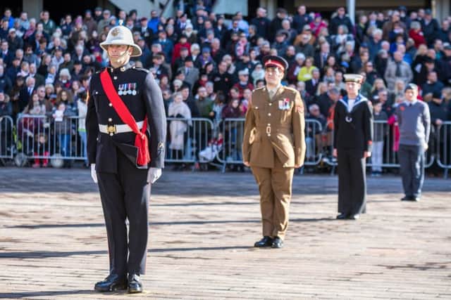 SOLEMNITY Observing the silence at Portsmouths Guildhall Square Pictures: Mike Cooter (171547-258)