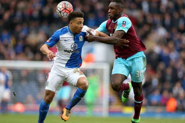 Blackburn Rovers' Adam Henley and West Ham United's Michail Antonio (right) battle for the ball. Picture : Martin Rickett/PA Wire.