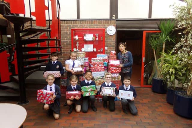 Year 4 teacher Caroline Fisk with pupils of Bosmere Junior School, who have collected 108 shoeboxes