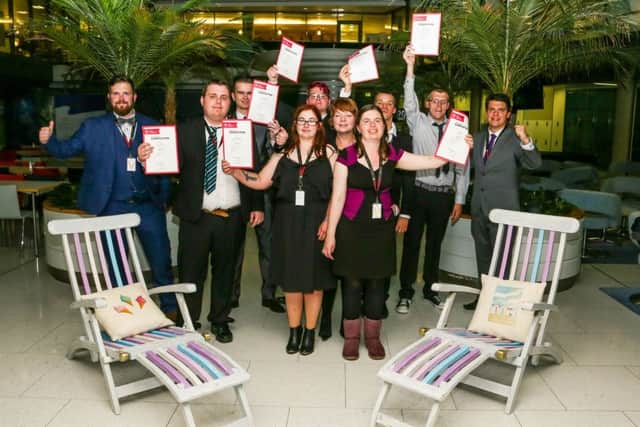 The Highbury College team at a celebration event at the Cunard offices in Southampton after finishing their project, with some deck chairs that they helped to restore and paint