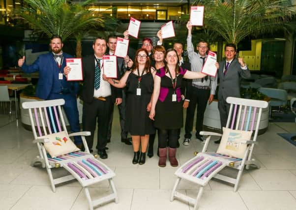 The Highbury College team at a celebration event at the Cunard offices in Southampton after finishing their project, with some deck chairs that they helped to restore and paint
