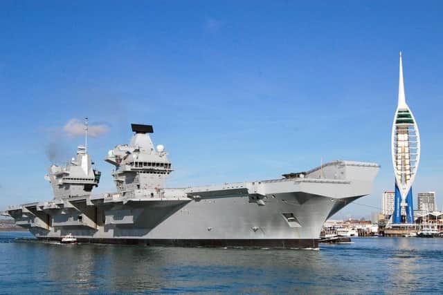 HMS Queen Elizabeth, the Royal Navy's new aircraft carrier, as she left Portsmouth for the first time
