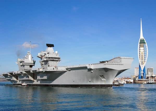HMS Queen Elizabeth, the Royal Navy's new aircraft carrier, as she left Portsmouth for the first time