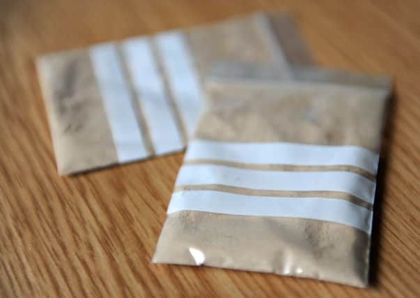 File photos of bags of heroin