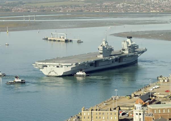 HMS Queen Elizabeth aircraft carrier leaves Portsmouth Naval Base for the first time on October 30. 

Picture: Malcolm Wells