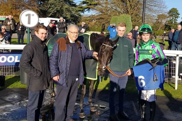 Jockey Tom Bellamy, right, celebrates victory on Markov