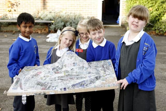 Yousef Alam 6, Isabella Doyle 6, Halle Wellham 6, George McKechnie 6 and Isabel Manchip 6 with one of the islands they made out of papier mache