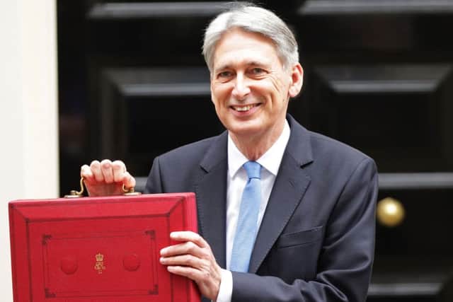 Chancellor Philip Hammond holding his red ministerial box outside 11 Downing Street, London, before heading to the House of Commons to deliver his Budget