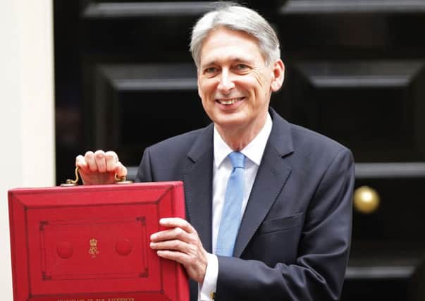 Chancellor Philip Hammond holding his red ministerial box outside 11 Downing Street, London, before heading to the House of Commons to deliver his Budget